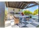 Outdoor kitchen with built-in grill, checkerboard patio, and seating area at 21961 E Via De Arboles St, Queen Creek, AZ 85142