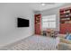 Playroom featuring a TV, built-in shelves, and a colorful rug at 21961 E Via De Arboles St, Queen Creek, AZ 85142