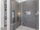 Walk-in shower with built-in seat and gray tile at 21961 E Via De Arboles St, Queen Creek, AZ 85142