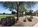 Peaceful common area with rocking chairs under a tree at 2206 S Ellsworth Rd # 72B, Mesa, AZ 85209