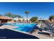 Community pool with plenty of lounge chairs for sunbathing at 2206 S Ellsworth Rd # 72B, Mesa, AZ 85209