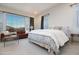 Serene bedroom with large window, plush bedding, and comfortable seating area at 22665 E Stacey Rd, Queen Creek, AZ 85142