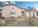 Landscaped front yard with gravel, small plants, and a tan house at 22665 E Stacey Rd, Queen Creek, AZ 85142