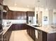Gourmet kitchen featuring granite countertops, stainless steel appliances, and ample dark wood cabinet storage space at 22665 E Stacey Rd, Queen Creek, AZ 85142