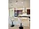 Bright kitchen featuring an island with pendant lighting, stainless steel appliances, and dark wood cabinetry at 22665 E Stacey Rd, Queen Creek, AZ 85142