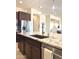 Close up of kitchen island featuring granite countertops, stainless steel appliances, and dark wood cabinetry at 22665 E Stacey Rd, Queen Creek, AZ 85142