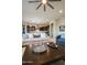 Open-concept living room featuring a plush sofa, modern ceiling fan, and seamless flow into the kitchen at 22665 E Stacey Rd, Queen Creek, AZ 85142