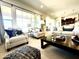 Bright living room featuring oversized windows, neutral decor, comfortable seating, and modern coffee table at 22665 E Stacey Rd, Queen Creek, AZ 85142