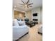 Inviting living room with fireplace, TV, comfortable seating, and modern ceiling fan at 22665 E Stacey Rd, Queen Creek, AZ 85142
