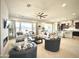 Open-concept living room featuring a modern fireplace, stylish seating, and a ceiling fan at 22665 E Stacey Rd, Queen Creek, AZ 85142