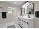 Bathroom with white double vanity and hexagonal marble floor tiles at 2366 E Becker Ln, Phoenix, AZ 85028