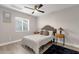 Bedroom with a queen bed, ceiling fan and wood-toned nightstand at 2366 E Becker Ln, Phoenix, AZ 85028