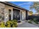 Mid-century modern home entrance with a black metal door and landscaped walkway at 2366 E Becker Ln, Phoenix, AZ 85028