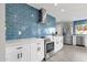 White kitchen with stainless steel appliances and blue tile backsplash at 2366 E Becker Ln, Phoenix, AZ 85028