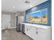 Modern kitchen with white cabinets, farmhouse sink, and stainless steel appliances at 2366 E Becker Ln, Phoenix, AZ 85028