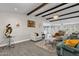 Open concept living room with hardwood floors, exposed beams, and view into kitchen at 2366 E Becker Ln, Phoenix, AZ 85028