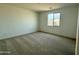 Bright bedroom featuring a plush carpet and a window offering natural light at 2446 E Spur Dr, San Tan Valley, AZ 85140