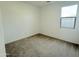 Neutral bedroom showcasing plush carpeting and a bright window at 2446 E Spur Dr, San Tan Valley, AZ 85140