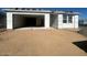 Unfinished home's exterior with a large garage door and sandy landscaping at 2446 E Spur Dr, San Tan Valley, AZ 85140