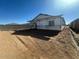 Unfinished home's rear elevation under construction, showcasing backyard at 2446 E Spur Dr, San Tan Valley, AZ 85140