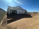 Unfinished home's rear elevation showcasing the patio and surrounding area at 2446 E Spur Dr, San Tan Valley, AZ 85140