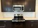 Close-up of a stylish kitchen, featuring stainless steel oven and microwave at 2446 E Spur Dr, San Tan Valley, AZ 85140