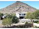 Two-story house with solar panels and a mountain view in the background at 25210 N 54Th Dr, Phoenix, AZ 85083