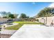 Landscaped backyard with fire pit, patio, and hanging chair at 25210 N 54Th Dr, Phoenix, AZ 85083