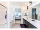 Modern bathroom with double vanity, walk-in shower, and bedroom view at 25210 N 54Th Dr, Phoenix, AZ 85083