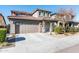 Two-story house with tan siding, brown roof, and a two-car garage at 25210 N 54Th Dr, Phoenix, AZ 85083