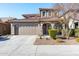 Two-story house with tan siding, brown roof, and a two-car garage at 25210 N 54Th Dr, Phoenix, AZ 85083