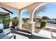 Covered porch with arched entryway, wicker chairs, and decorative lanterns at 25210 N 54Th Dr, Phoenix, AZ 85083