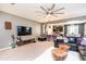 Living room with sectional sofa, TV, and kitchen island view at 25210 N 54Th Dr, Phoenix, AZ 85083