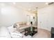 Light and airy living room featuring a beige couch and a black coffee table at 25210 N 54Th Dr, Phoenix, AZ 85083