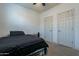 Small bedroom with a double bed and two closets at 25973 W Horsham Dr, Buckeye, AZ 85396