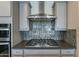 Modern kitchen with stainless steel appliances and gray cabinets at 25973 W Horsham Dr, Buckeye, AZ 85396