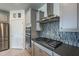 Kitchen features stainless steel appliances and gray cabinetry at 25973 W Horsham Dr, Buckeye, AZ 85396