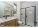 Modern bathroom with a walk-in shower and wood vanity at 2700 N 216Th Ave, Buckeye, AZ 85396