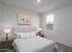 Bright bedroom with a queen bed and neutral decor at 2700 N 216Th Ave, Buckeye, AZ 85396