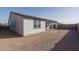 Home's back exterior, showing patio and unlandscaped yard at 2732 N 217Th Ave, Buckeye, AZ 85396