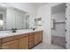 Double vanity bathroom with modern light fixtures and walk-in shower at 2732 N 217Th Ave, Buckeye, AZ 85396