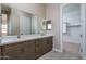 Double vanity bathroom with walk-in closet at 2732 N 217Th Ave, Buckeye, AZ 85396