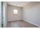 Simple bedroom with wood-look floors and window at 2732 N 217Th Ave, Buckeye, AZ 85396