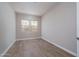 Simple bedroom with two windows and wood-look tile floors at 2732 N 217Th Ave, Buckeye, AZ 85396