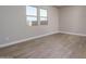 Bright bedroom with two windows and wood-look tile floors at 2732 N 217Th Ave, Buckeye, AZ 85396