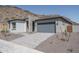 Modern home with gray garage door and stone accents at 2732 N 217Th Ave, Buckeye, AZ 85396