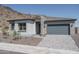 New construction home with gray garage and stone fireplace at 2732 N 217Th Ave, Buckeye, AZ 85396