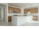 Modern kitchen with light wood cabinets, marble countertops and island at 2732 N 217Th Ave, Buckeye, AZ 85396