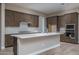 Modern kitchen with island, stainless steel appliances, and ample cabinetry at 2732 N 217Th Ave, Buckeye, AZ 85396