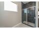 Modern shower with glass enclosure and dark tile at 2732 N 217Th Ave, Buckeye, AZ 85396